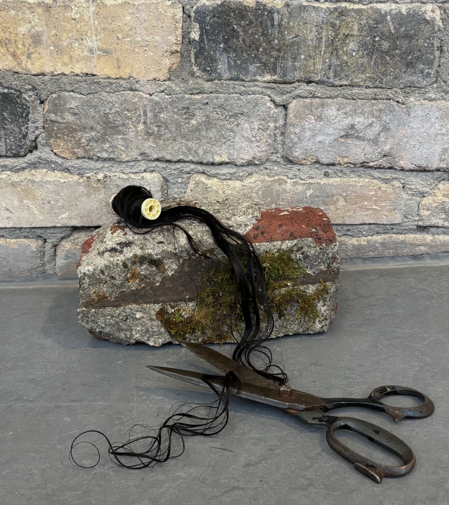 Hair bobbin on brick found at abandoned factory.