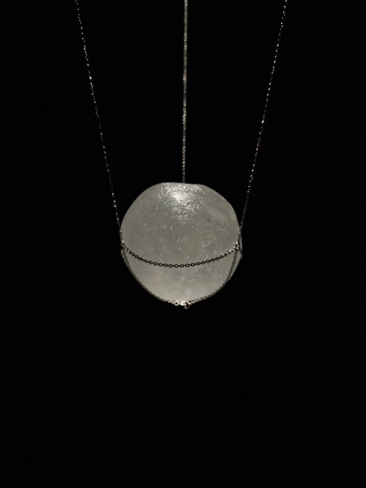 *Suspended Sphere*, solid cast crystal glass, stainless steel chains, diameter 85 mm.