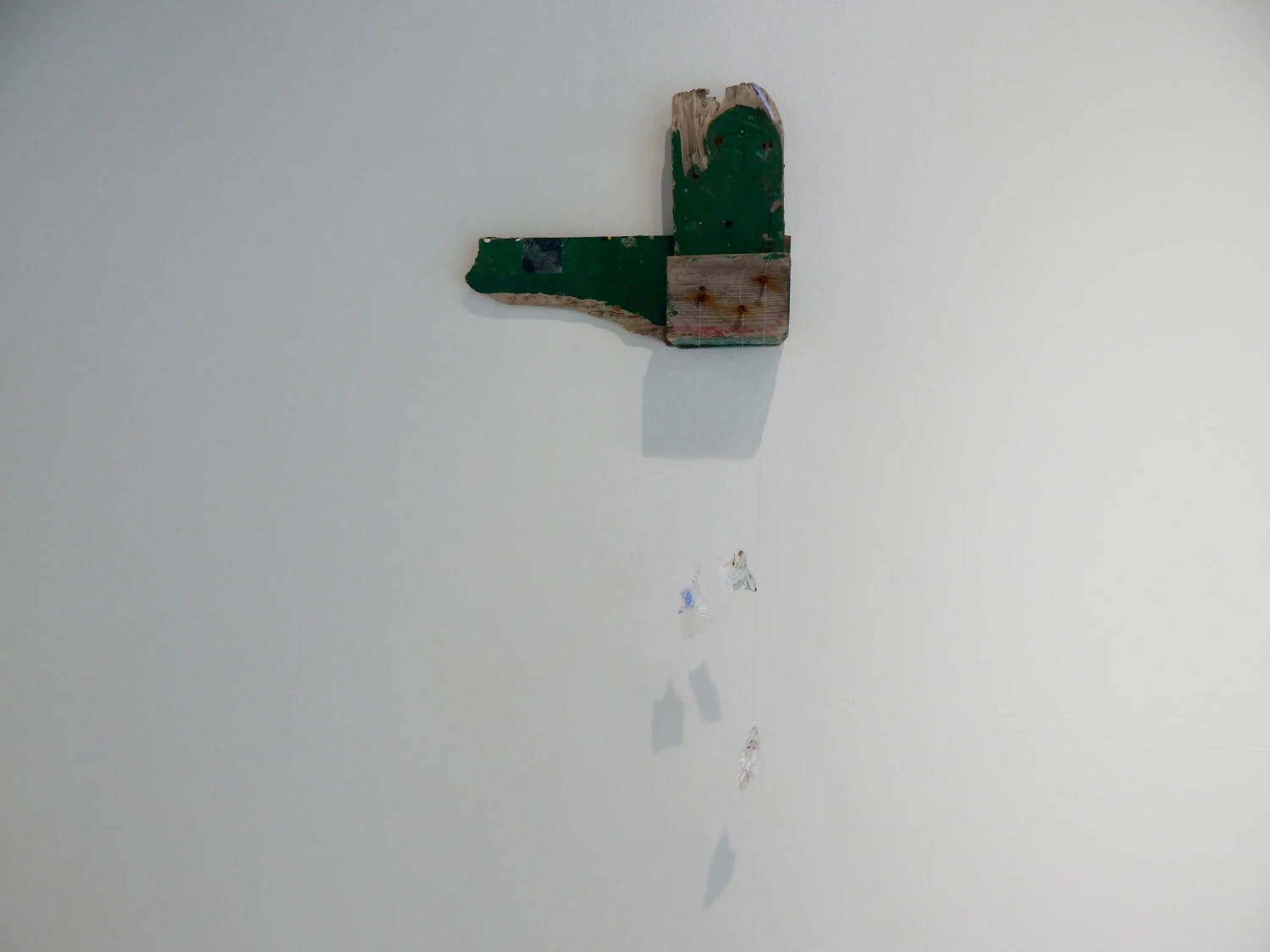 Installation view of *That day on the bench by the sand dunes*, 2026, found wood, resin, found Netelia Ichneumon wasps, acetate, glitter, thread, image transfer, gouache.