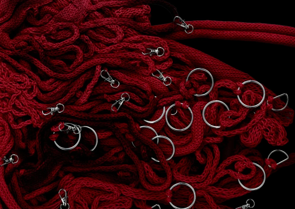 Spray painted partial knit loops paired with silver rings.