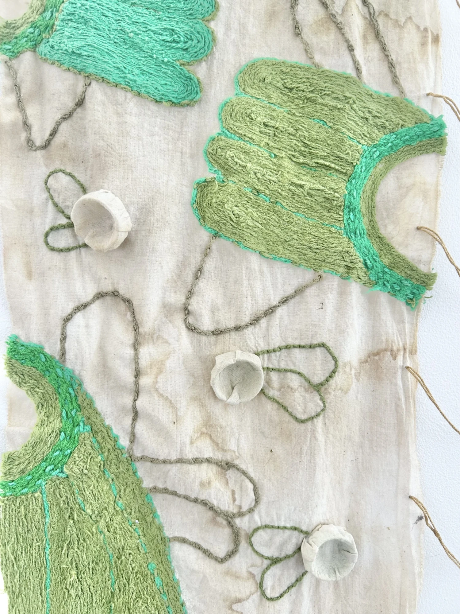 Close up of left wall hanging: needle felting, embroidery, fabric manipulation and natural dye