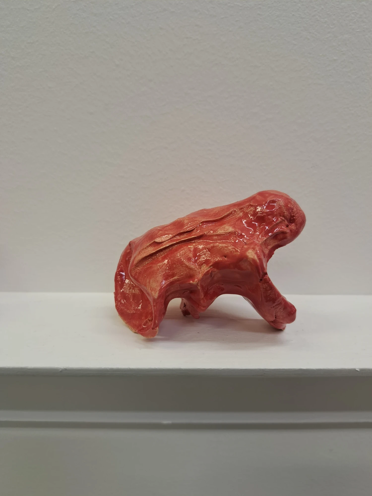 Close-up on one clay piece on shelf.