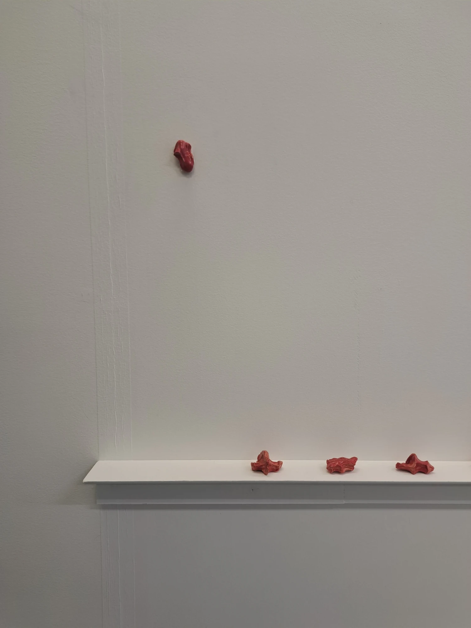 Close-up of shelf and wall clay pieces.