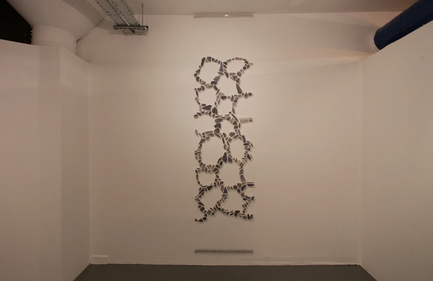 *Floating Freely*, collage on Japanese paper, string, aluminium bracket, fishing weights, 0.7 x 2.9 m.