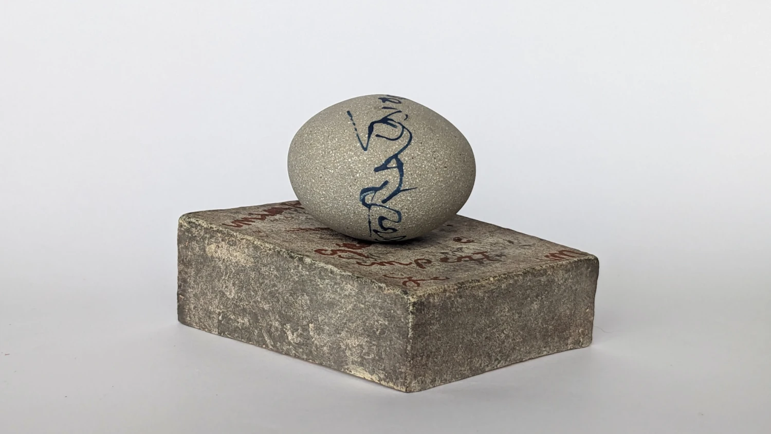 *Asemic Orb*, stoneware with text, 8 x 9 x 7.5 cm.
