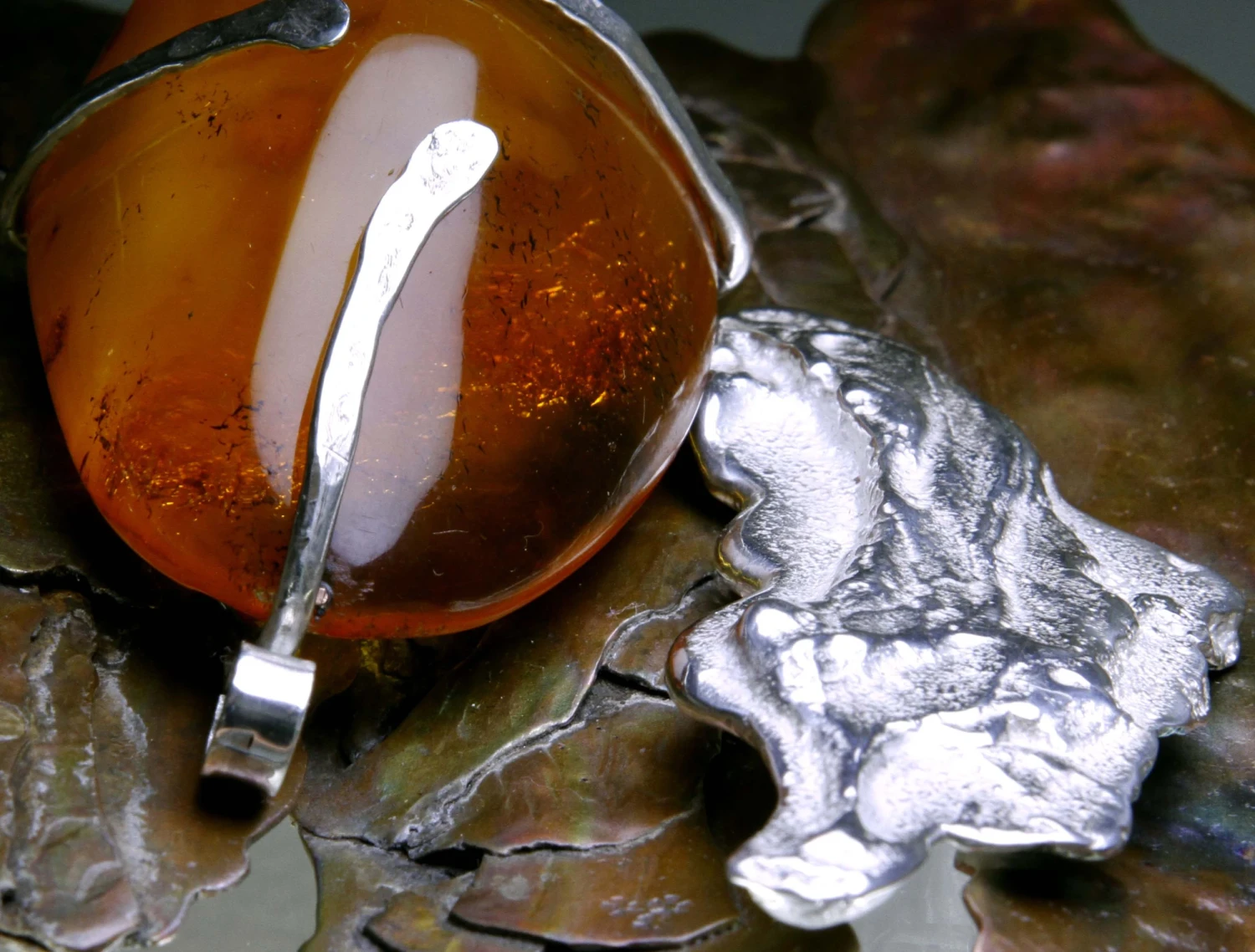 Detail of *Tree Bark Effect*, mixed-metal necklace with amber pendant.