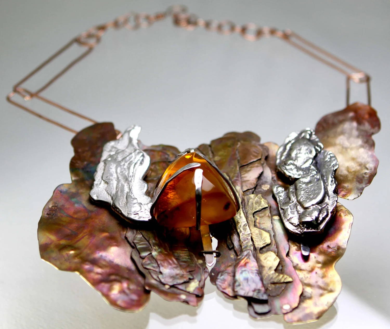 *Tree Bark Effect*, mixed-metal necklace with amber pendant.