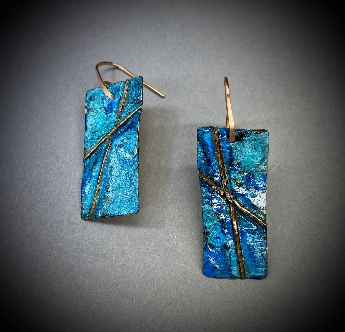 *Crossed Wires*, patinated copper, 5 x 2 cm.