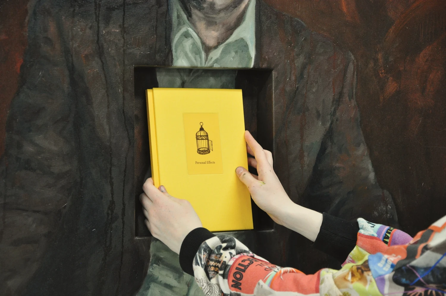 A shelf constructed within the painting holds an archive of *Personal Effects*.