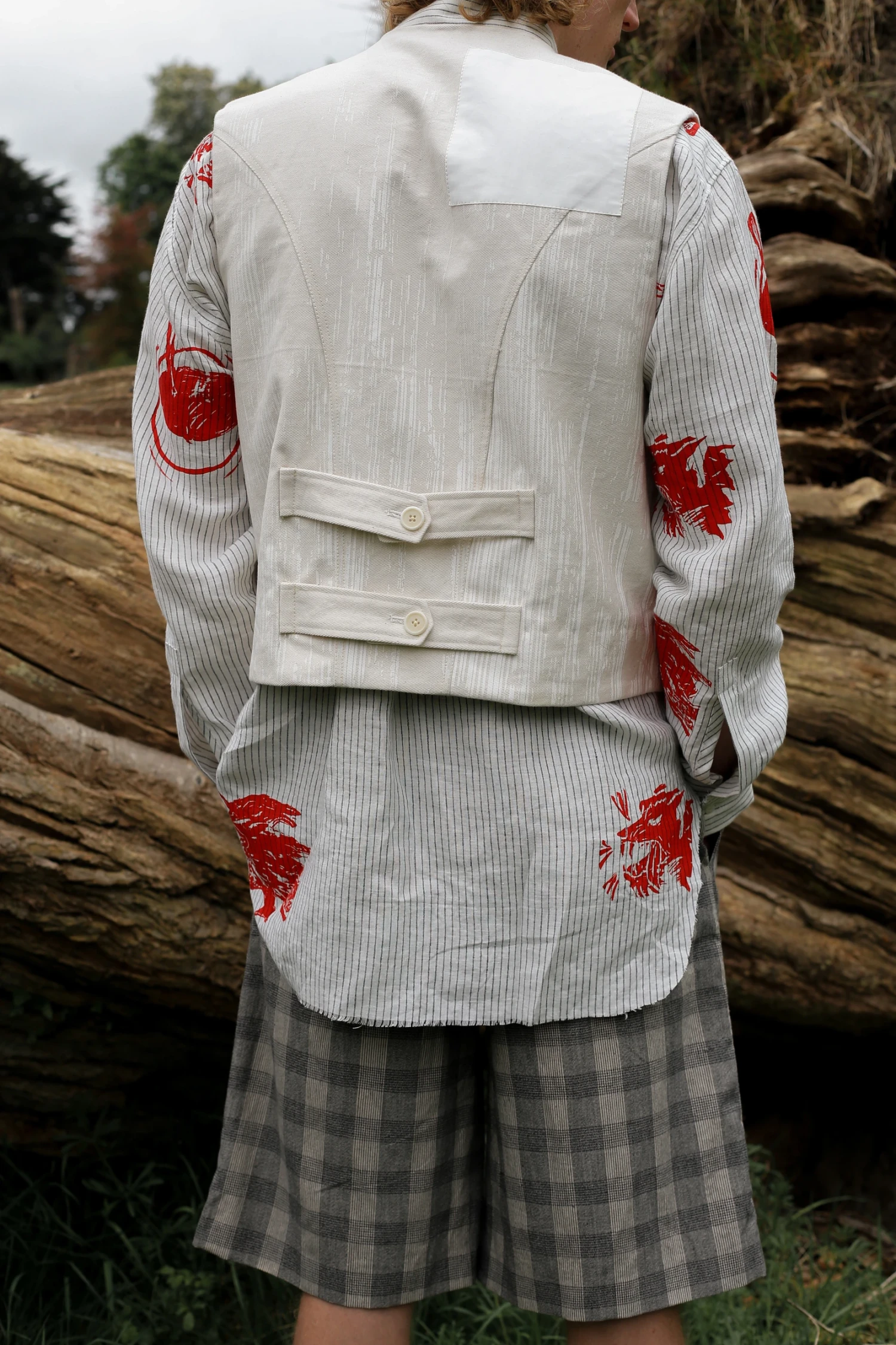 Luke wearing screen printed Irish linen shirt with un-dyed denim vest featuring screen print by Textile & Surface Design student, Dan Casey with checked cotton pleated shorts. Image credit: Ella O'Brien.
