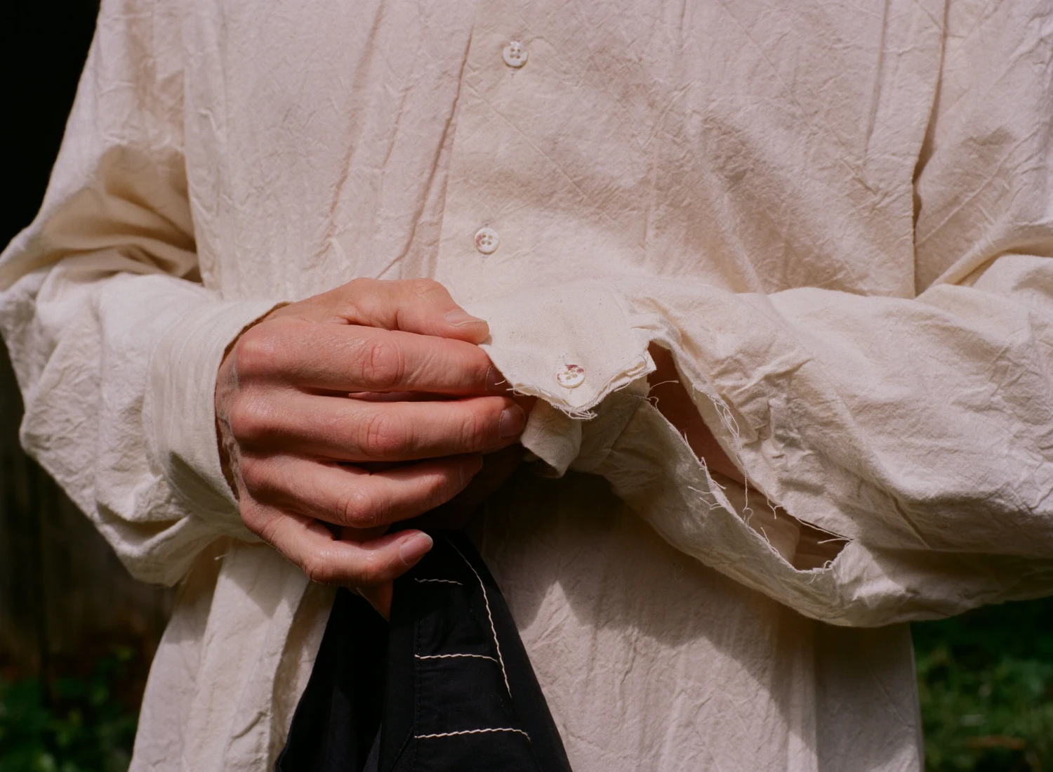 Close-up of washed calico shirt with second hand shell buttons and raw finish. Image credit: Ella O'Brien.