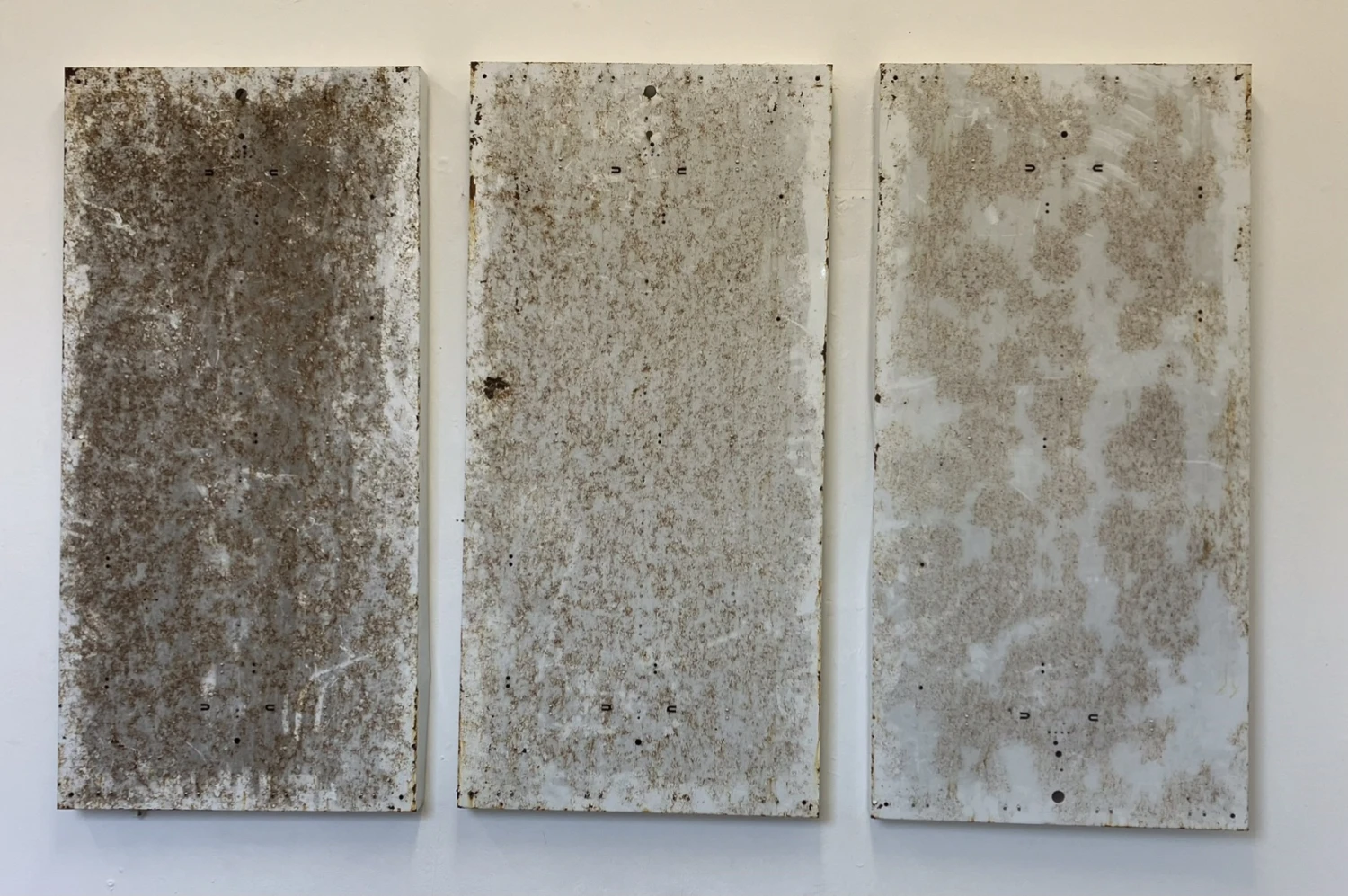 Corroded metal light fixture covers reclaimed from The Field, NCAD.