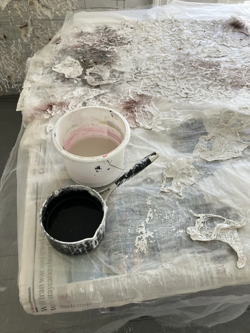 Preparation of wire mesh and plaster bandage assemblage in studio.