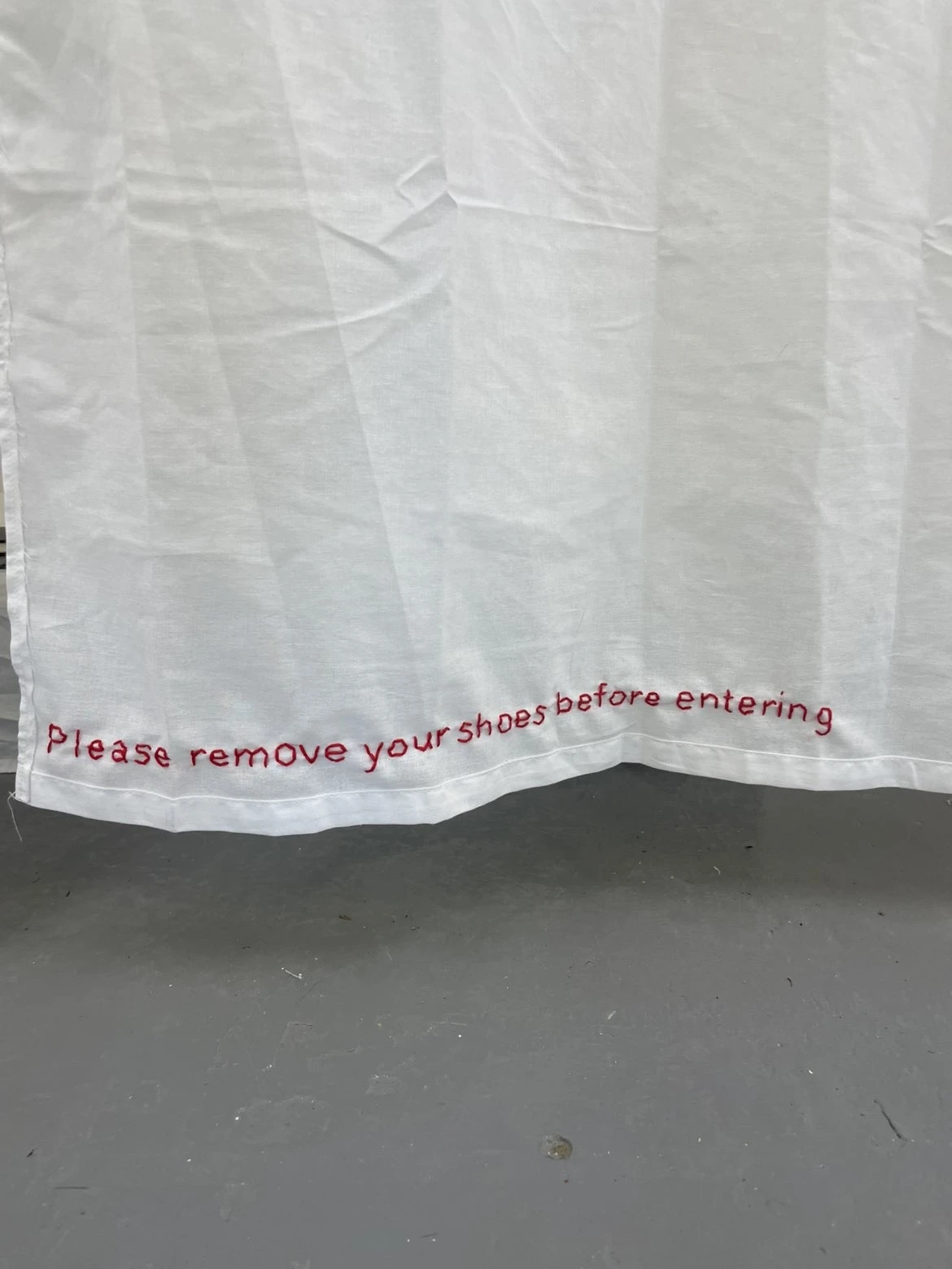 Installation view, NCAD Works 2026, embroidered audience instruction text.