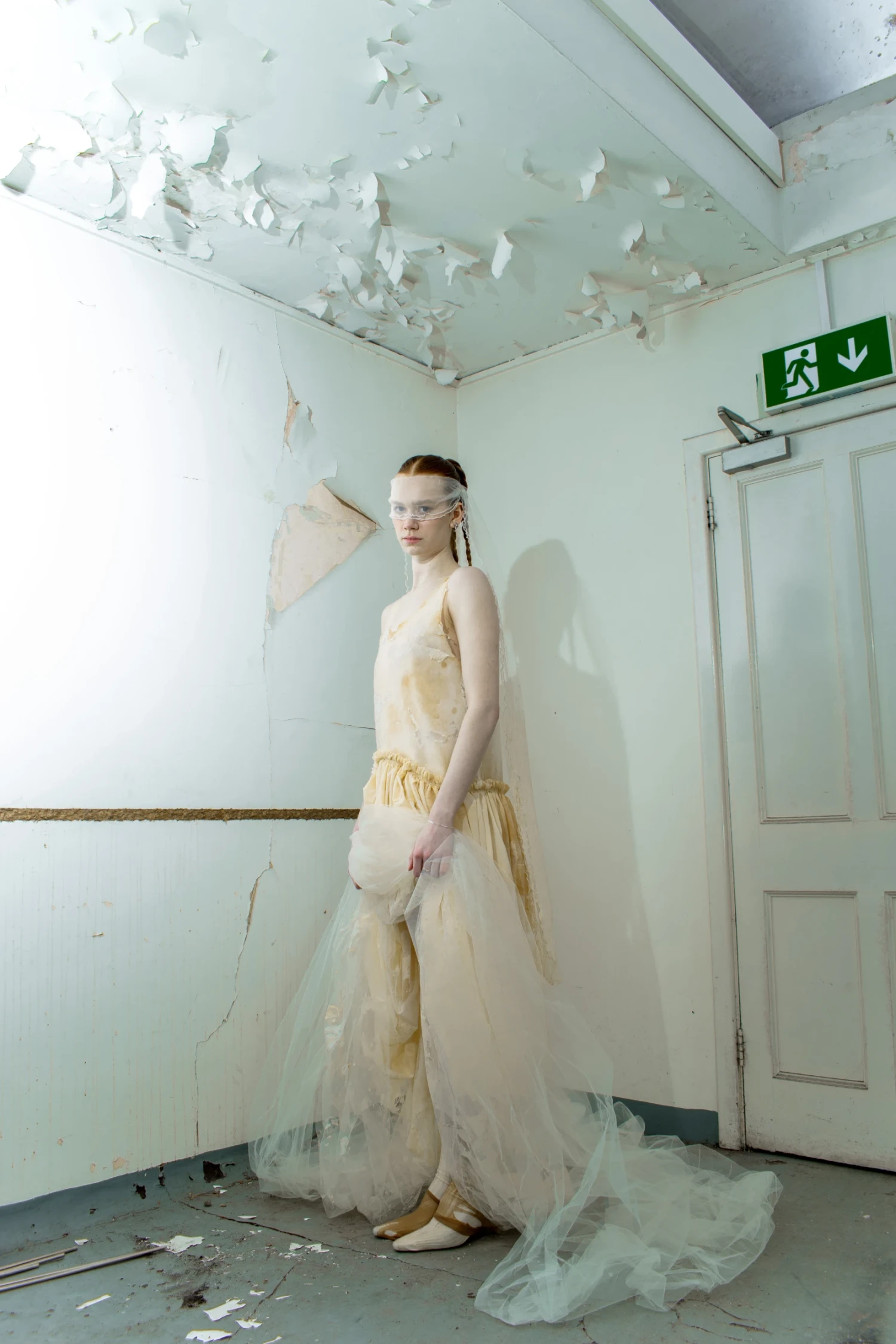 Look 2 , *Johnnie* Gown, latex and veiling tulle gown inspired by the proportions of a tank top; *Facial* Veil, veiling tulle dipped in latex with baby locked edges.