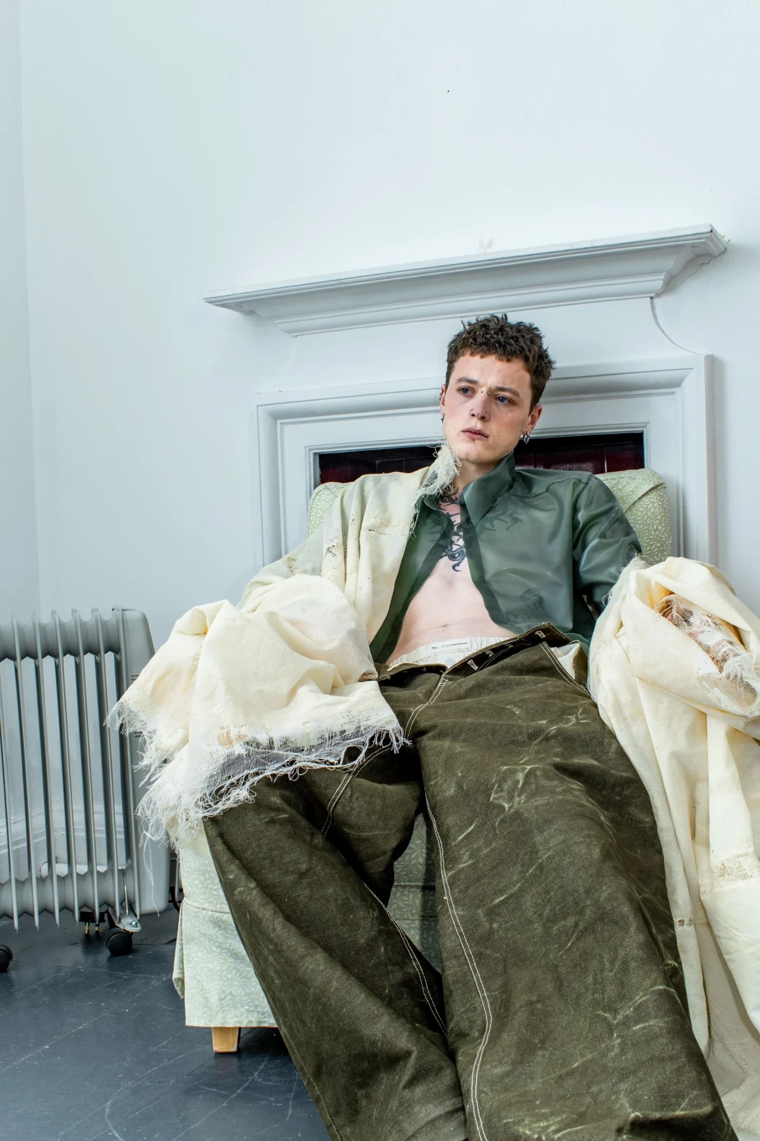 Look 3, *Throat* Coat, oversized coat constructed from translucent latex gauze;* Thin Feel* Shirt, semi-transparent latex sheeting shirt;* Uncut* Jeans, oversized olive denim jeans with a buffalo leather patch.