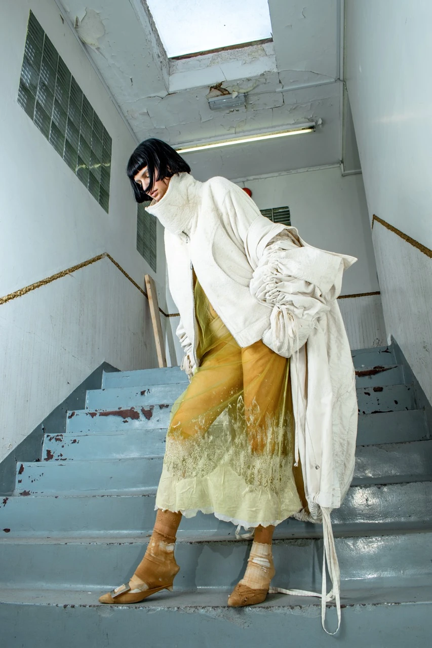 Look 1, *One Night* Coat, distressed tea-stained quilted cotton coat with embroidery and exaggerated drawstring detailing; *Used* Bomber, towelling bomber jacket splashed with latex; *Raw* Slip, latex-dipped hand dyed tulle shift dress.