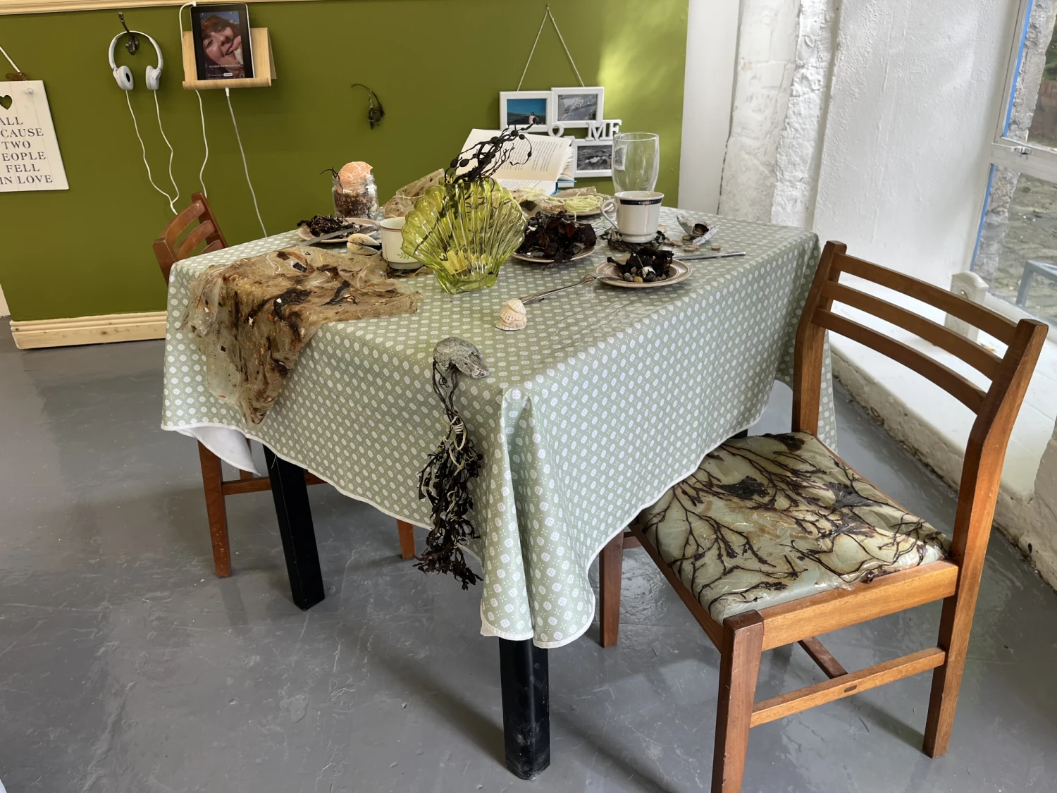 Seaweed leather upholstered vintage 60s chairs, table, oil cloth, seaweed leather, trinkets, china, cutlery, periwinkles, sewing needles, dillisk, 'Banshee' book, lavalier mic, Fishermans Friends.