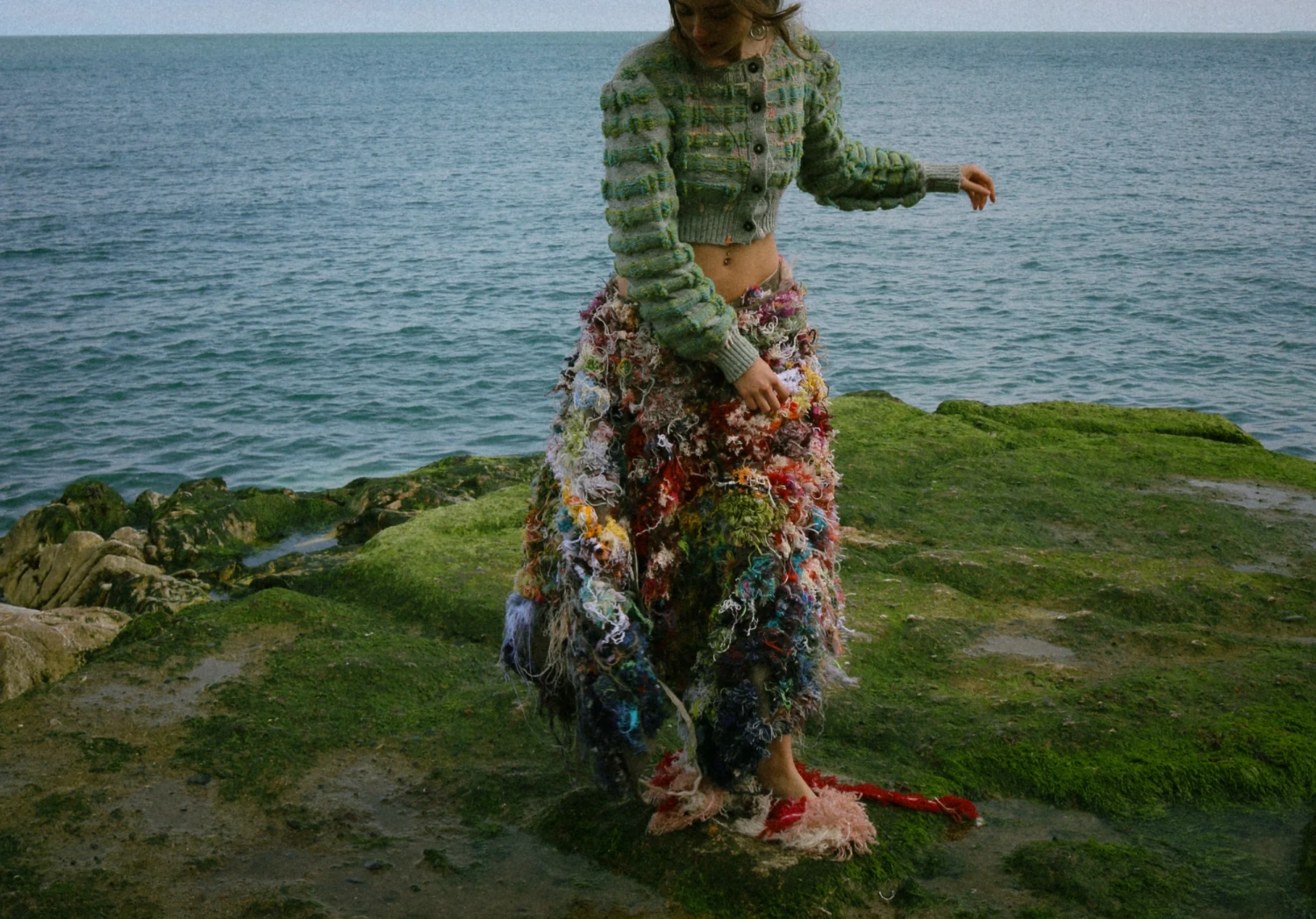 Mountain avans skirt with greencastle jumper. Tufted wearable wall hanging created by tufting waste yarn worn with knitted cardigan named after greencastle Donegal yarn.