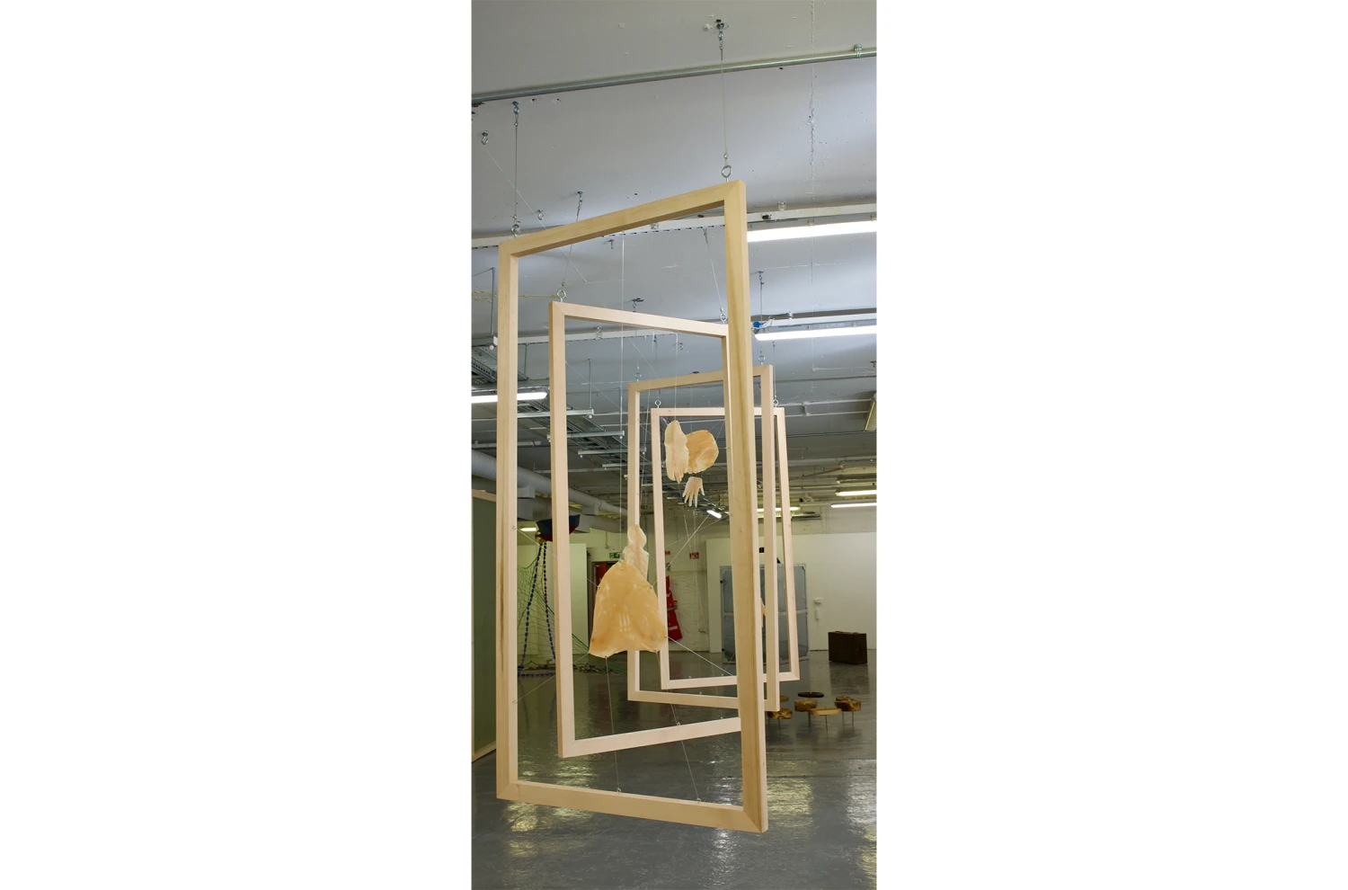 *This Body is My Body*, oak wood hand-made frames, stretched latex with metal hooks, 185.42 x 91.44 cm.