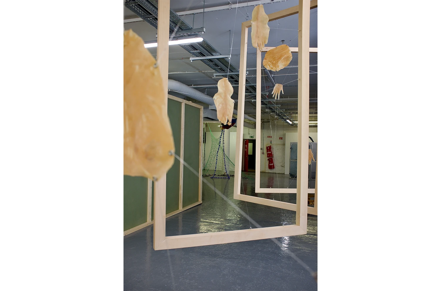 *This Body is My Body*, oak wood hand-made frames, stretched latex with metal hooks, 185.42 x 91.44 cm.