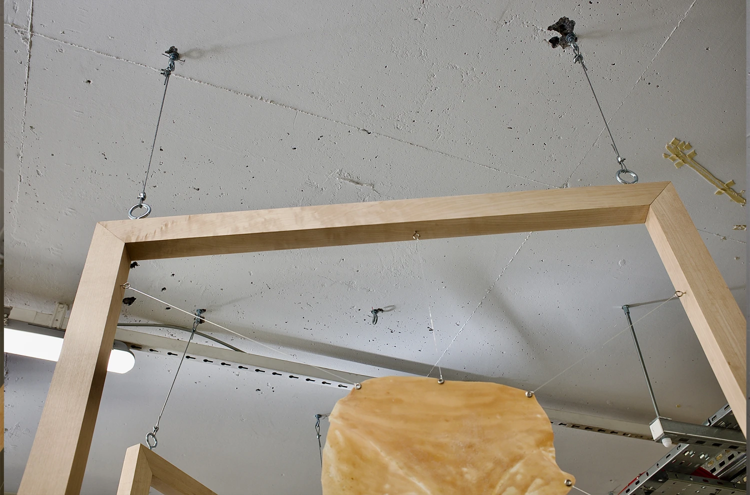 *This Body is My Body*, oak wood hand-made frames, stretched latex with metal hooks, 185.42 x 91.44 cm.
