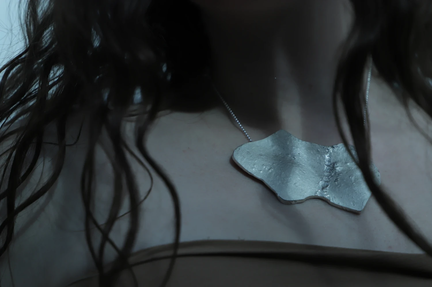 *What The Body Kept*, wax-cast sterling silver pendant, created from a direct body impression.