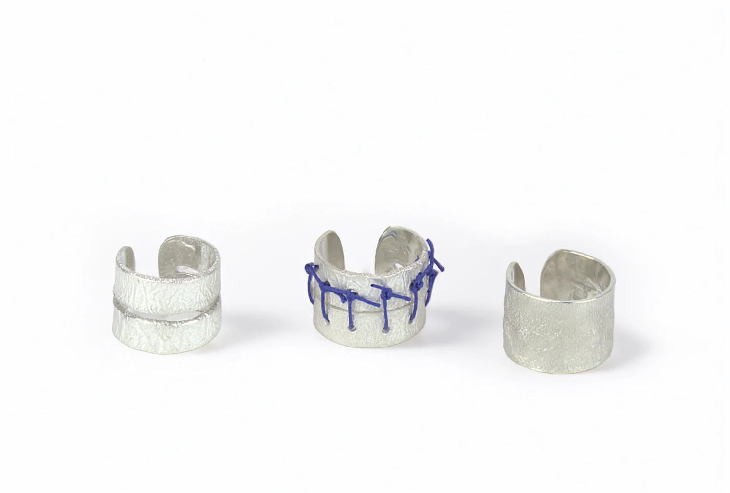 *Becoming Whole* (stages of scar healing) series, three 935 silver rings, electric blue leather thread used on #2 ring.