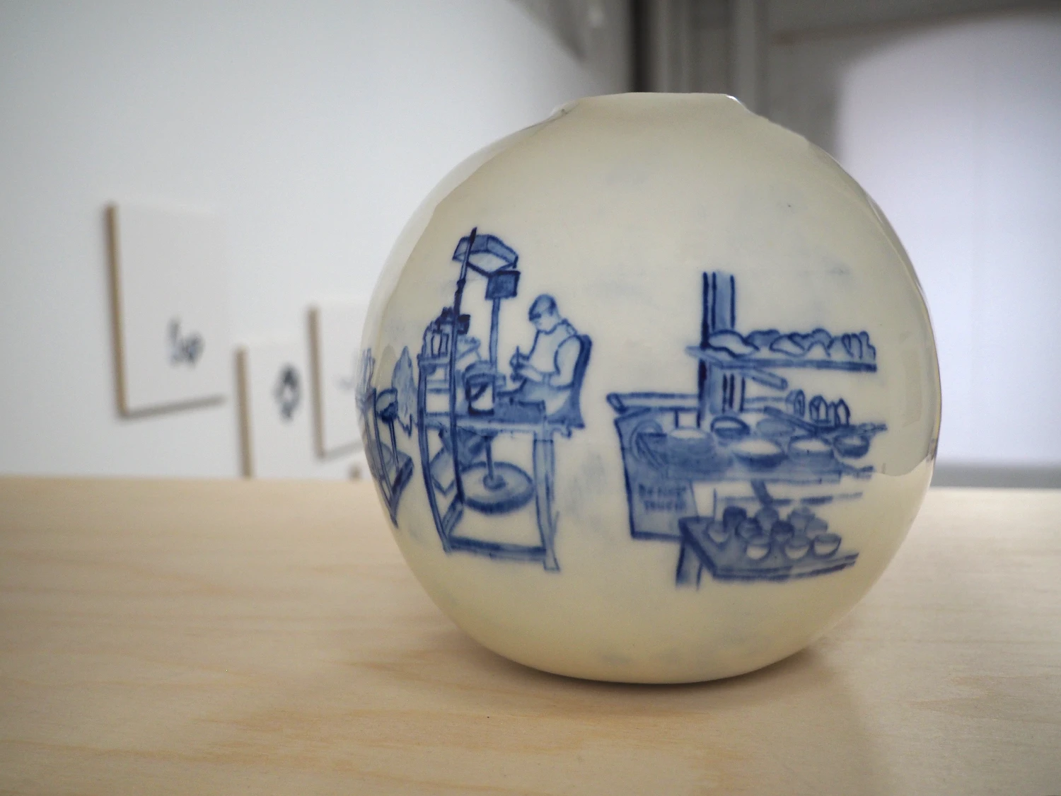 *Delft*, paper porcelain vessel painted with cobalt oxide depicting the workers at Royal Delft making Delft Blue ceramics.