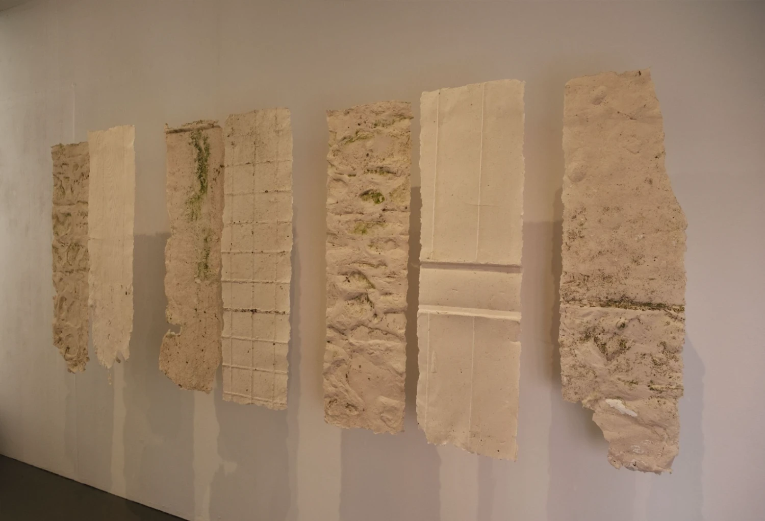 *Holdings*, series of suspended handmade paper casts.