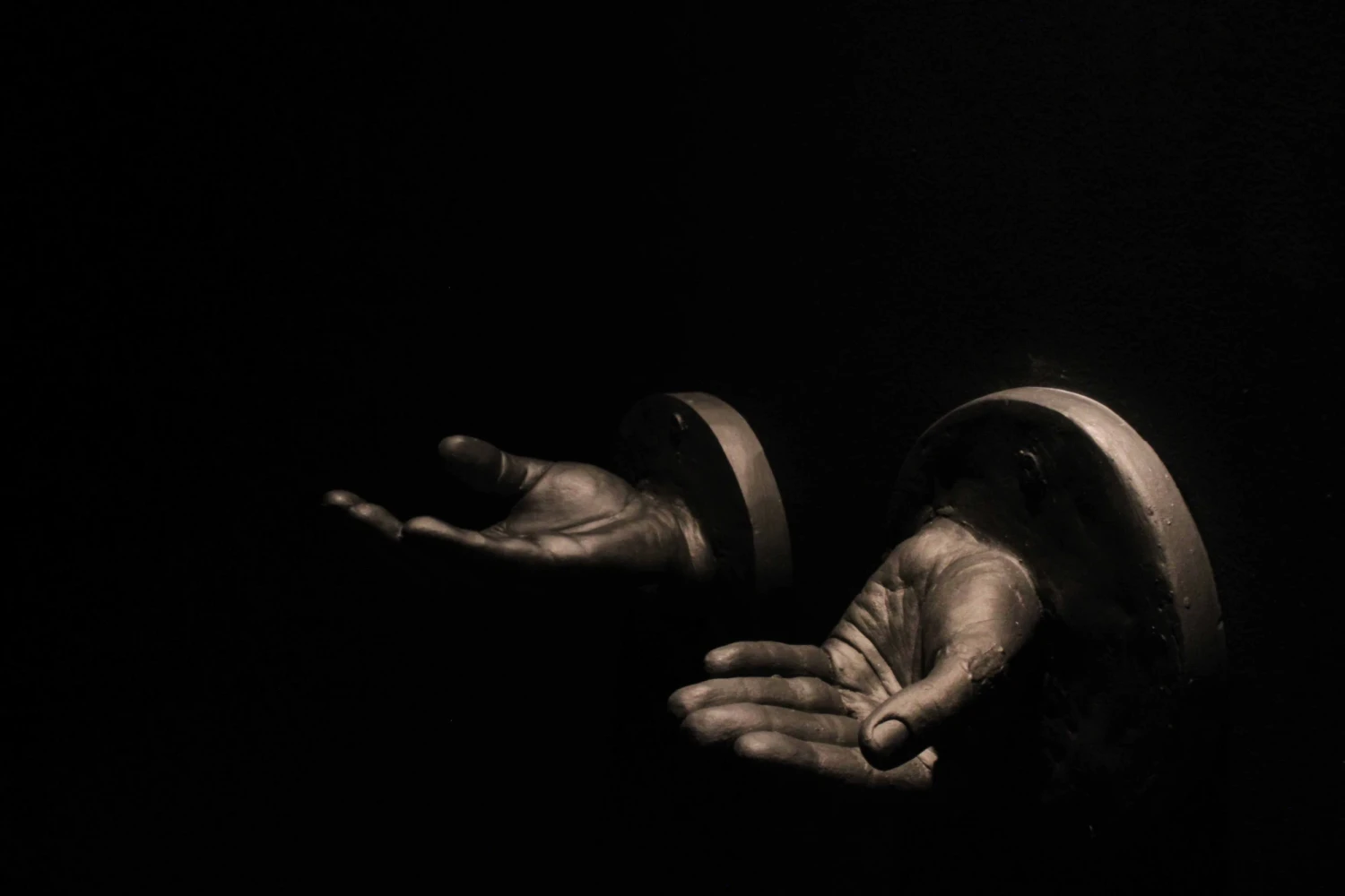 Plaster hands covered in powdered graphite.