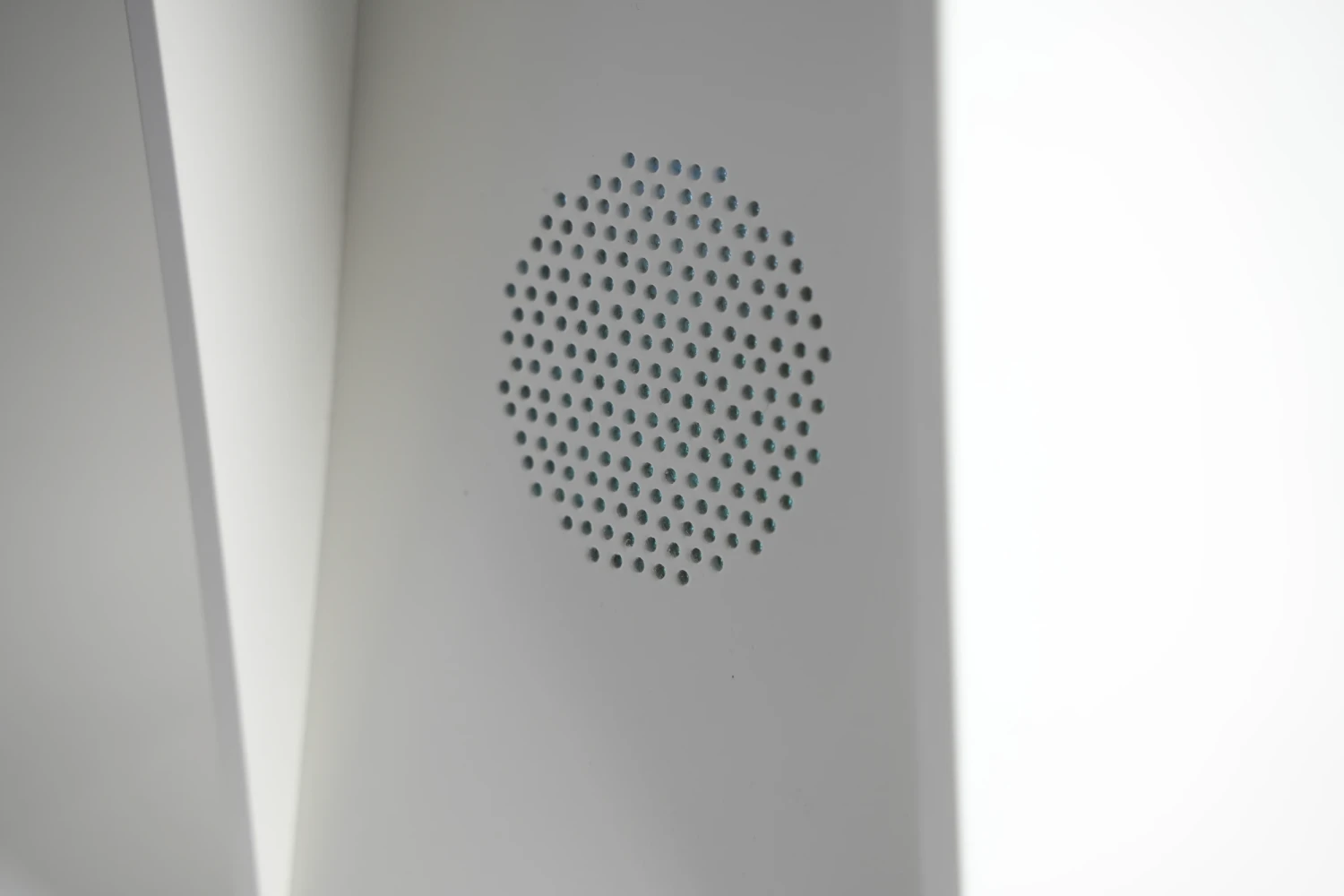 Integrated speaker grille for audio output of the generated voice.
