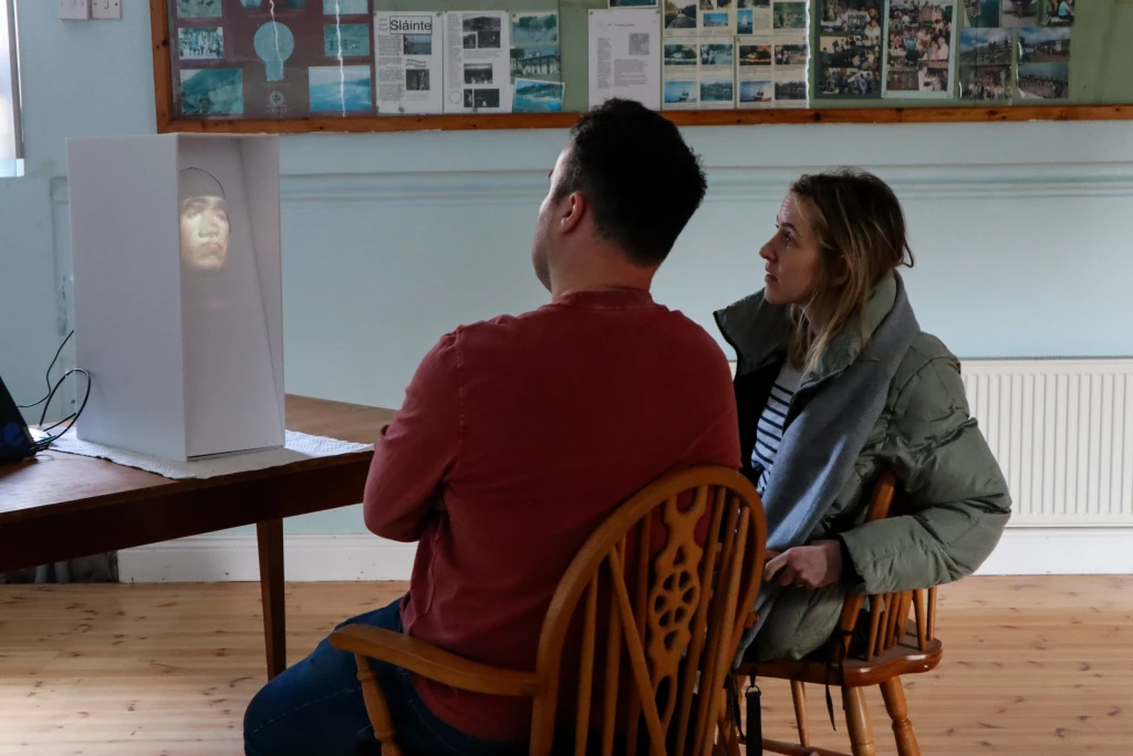Two participants listen to local stories held by the robot.